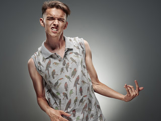 Emotional portrait of a teenager playing on air guitar
