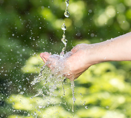 hand in the water in nature