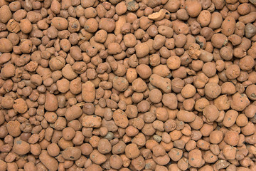 Heat expanded clay pebbles used as a growing media in hydroponics. Background close up of pellets.