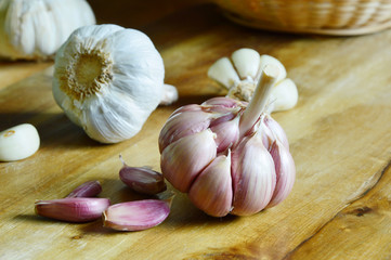 Surprising benefits of garlic for optimal health.
garlic on wooden board.  

