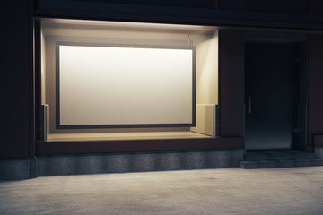 Storefront with billboard at night