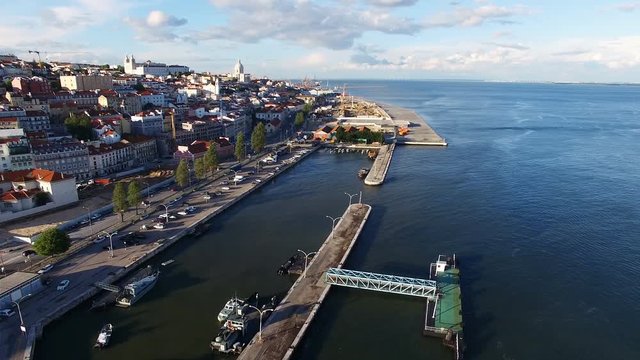 Portugal 4k travel video background. Aerial drone panoramic view of old city Lisbon, Alfama. Waterfront, ocean river marina port dock, boats ships