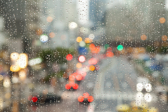 Defocused city view through rainy window