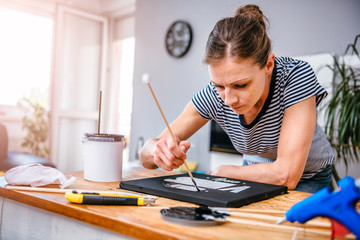 Woman painting on canvas