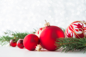 Red xmas ornaments on glitter holiday background. Merry christmas card. Winter theme. Happy New...
