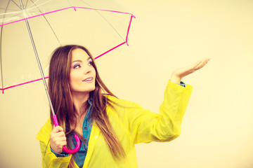 Woman in rainproof coat with umbrella. Forecasting