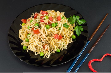 noodles with tomato and peas in a bowl