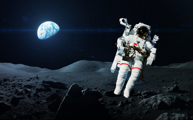 Brave astronaut at the spacewalk on the moon. This image elements furnished by NASA