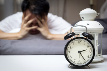 asian man in bed suffering insomnia and sleep disorder thinking about his problem at night