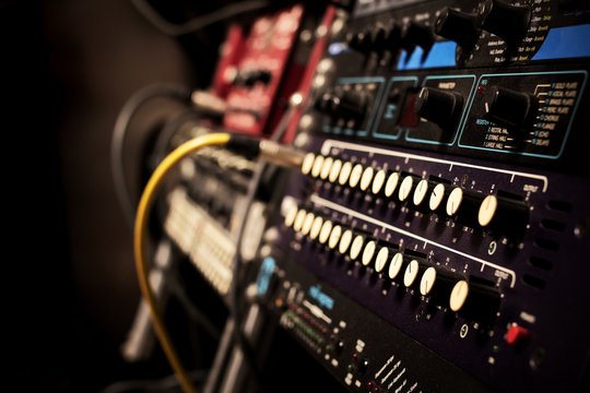 recording studio gears in rack, focus to knob & shallow dept of field