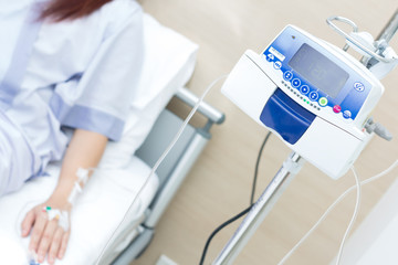 IV solution in a patient hand and IVS machine
