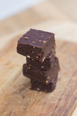 Homemade chocolate brownies over wooden background