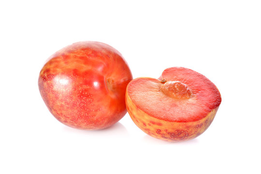 whole and half cut Pluot on white background