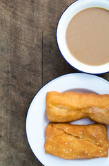coffee and fried bread on old table style Chinese and country