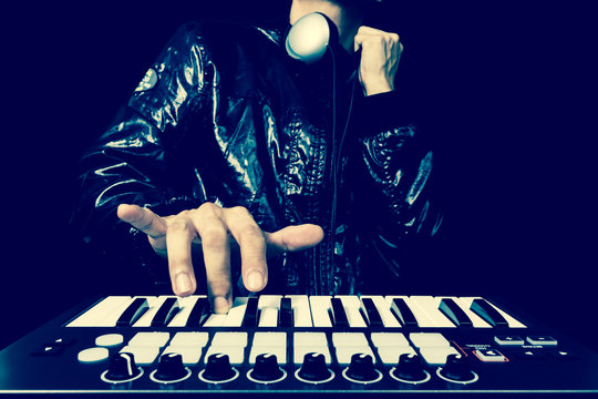 professional musician or DJ hands playing studio keyboard synthesizer, isolated on black for dance, groove, remix, underground background