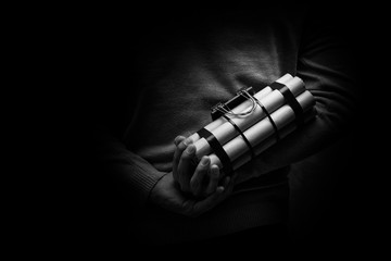 man in a black jacket strapped with explosives and detonator hol