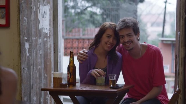 Portrait of young couple drinking beer and hanging out