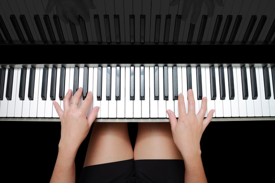 beautiful asian woman's hands playing on piano and reflection