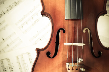 Naklejka premium violin on music sheet, vintage filter