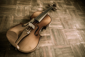 Fototapeta na wymiar vintage classical violin on wooden floor for music background