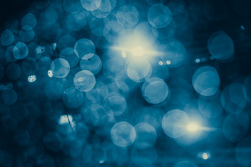 blur blue bokeh midnight raining on the road for background.