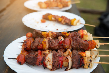 Closed up of Bar B Que (BBQ) on white dish,meat (chicken,pork,beef) and vegetable (tomato,onion,mushroom,pineapple)
