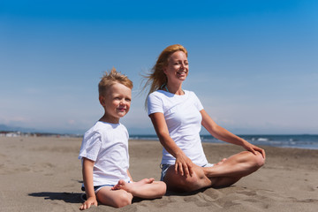 A young mother training with her son on the beach