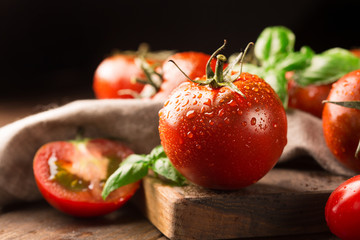 Fresh ripe organic tomatoes on old rustic background, selective focus © Iuliia Metkalova