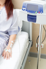 Fototapeta premium IV solution in a patient hand and IVS machine