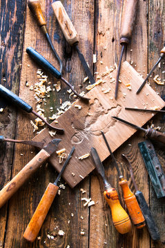 Chisels and carved piece of wood in traditional carpenter worksh