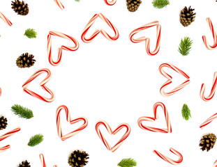 Christmas decoration: Christmas candy canes, pine cones and of fir branchs on white background with space for text. Flat lay