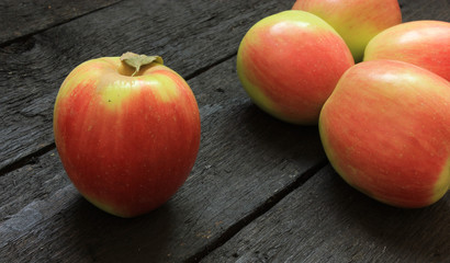 Ripe apples on wooden background