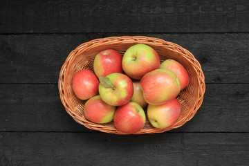 Apples in a basket on wooden background