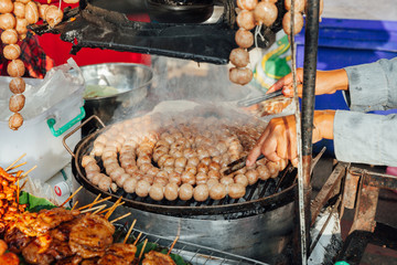 Thai woman cooks meatballs