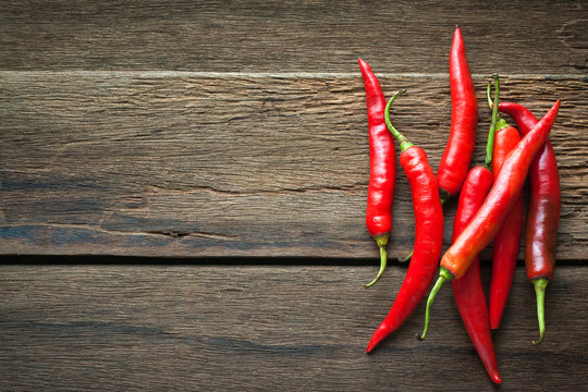 red chili peppers on dark wooden background