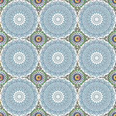 Seamless pattern with ethnic round ornament - mandalas in white, green, gold, blue and brown color scheme