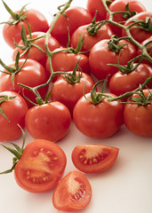 photo of very fresh tomatoes presented on white background