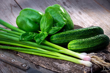 Fresh green vegetables on wooden background