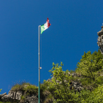Waving Italian flag on natural sky