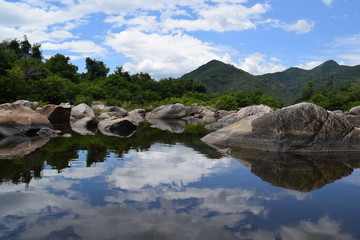 Fototapeta na wymiar fresh Ham Ho stream with rock reflect on water surface in Binh Dinh, vietnam