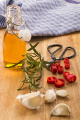 rosemary with sliced chili pepper, garlic, olive oil in a bottle