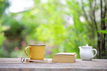 white vintage  teapot  with yellow mug and notebooks