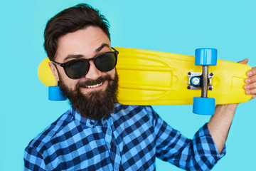Young hipster man with a skateboard