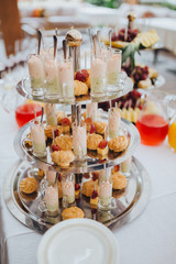 Snacks and drinks are on the table in the area of wedding buffet