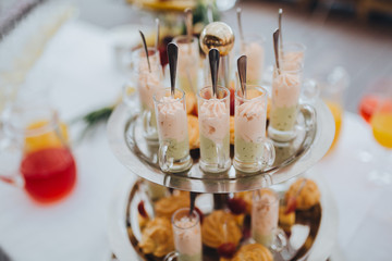 Snacks and drinks are on the table in the area of wedding buffet
