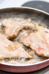 Frying pork meat in the frying pan