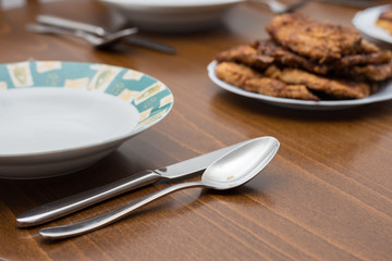 Breaded steaks served with fried potatoes