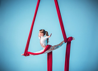 Graceful gymnast performing aerial exercise