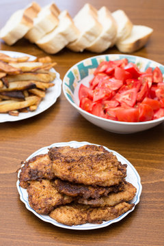 Breaded steaks served with fried potatoes