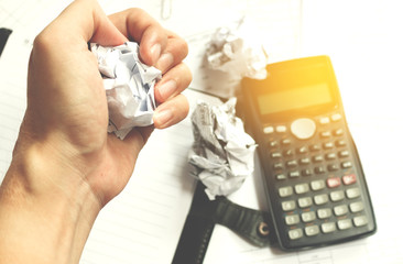 Businessman sitting at desk in a little office or home mad at wo